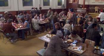 Movie still from “Life Stinks” (1991), directed by Mel Brooks – A group of people sitting at tables eating food; Wide shot, High angle
