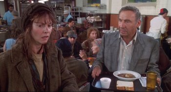Movie still from “Life Stinks” (1991), directed by Mel Brooks – A man and a woman sitting at a table with food; Medium shot, Over the shoulder angle