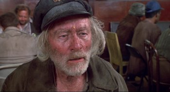 Movie still from “Life Stinks” (1991), directed by Mel Brooks – An older man with a beard and a hat; Close Up shot, High angle