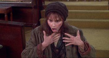 Movie still from “Life Stinks” (1991), directed by Mel Brooks – A woman with her hands in the air; Close Up shot, High angle