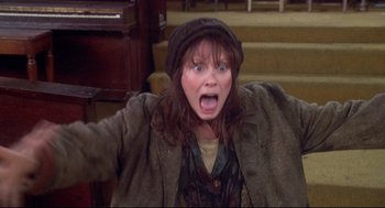 Movie still from “Life Stinks” (1991), directed by Mel Brooks – A woman in a hat and jacket is screaming; Medium shot, High angle