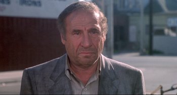 Movie still from “Life Stinks” (1991), directed by Mel Brooks – An older man wearing a suit and tie; Close Up shot, Low angle
