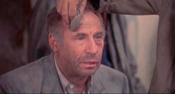 Movie still from “Life Stinks” (1991), directed by Mel Brooks – A man getting his hair cut by a barber; Close Up shot, Over the shoulder angle