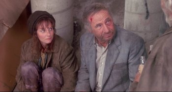 Movie still from “Life Stinks” (1991), directed by Mel Brooks – A man and a woman sitting next to each other; Medium shot, High angle