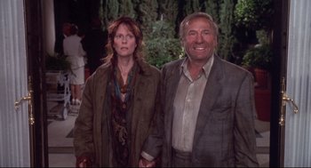 Movie still from “Life Stinks” (1991), directed by Mel Brooks – A man and a woman standing next to each other holding hands; Medium shot, Low angle