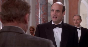 Movie still from “Life Stinks” (1991), directed by Mel Brooks – A man wearing a tuxedo talking to another man; Close Up shot, Over the shoulder angle