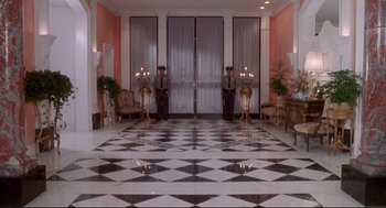 Movie still from “Life Stinks” (1991), directed by Mel Brooks – Two men standing in front of a door in a room; Extreme Wide shot, High angle