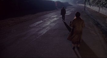 Movie still from “Life Stinks” (1991), directed by Mel Brooks – A man and a woman walking down a street at night; Wide shot, High angle