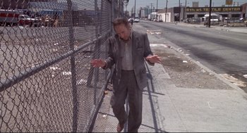 Movie still from “Life Stinks” (1991), directed by Mel Brooks – An older man in a suit is walking down the street; Wide shot, High angle