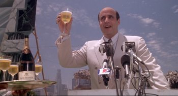 Movie still from “Life Stinks” (1991), directed by Mel Brooks – A man holding a glass of wine in his hand; Medium shot, Low angle