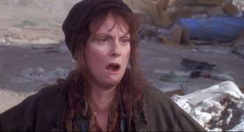 Movie still from “Life Stinks” (1991), directed by Mel Brooks – A woman with long red hair wearing a hat and looking surprised; Close Up shot, Low angle