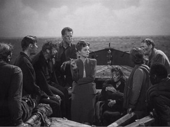 Movie still from “Lifeboat” (1944), directed by Alfred Hitchcock – A black and white photo of a group of people on a boat; Wide shot, High angle