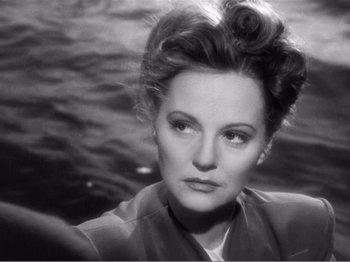 Movie still from “Lifeboat” (1944), directed by Alfred Hitchcock – An old photo of an older woman with big hair; Close Up shot, Over the shoulder angle