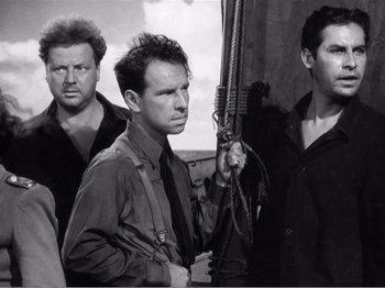 Movie still from “Lifeboat” (1944), directed by Alfred Hitchcock – A black and white photo of a group of men; Medium shot, Low angle