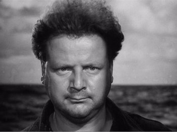 Movie still from “Lifeboat” (1944), directed by Alfred Hitchcock – A black and white photo of a man with a mohawk; Close Up shot, Low angle