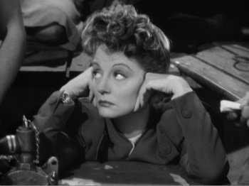 Movie still from “Lifeboat” (1944), directed by Alfred Hitchcock – An old black and white photo of a woman with her hands on her head; Close Up shot, High angle