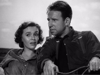 Movie still from “Lifeboat” (1944), directed by Alfred Hitchcock – A man and a woman standing next to each other; Medium shot, Low angle