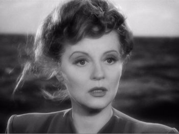 Movie still from “Lifeboat” (1944), directed by Alfred Hitchcock – An old photo of a woman with a big curly hair style; Close Up shot, High angle