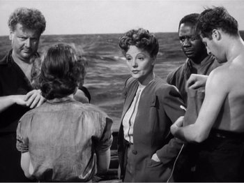 Movie still from “Lifeboat” (1944), directed by Alfred Hitchcock – A group of people standing on top of a boat; Medium shot, High angle