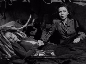 Movie still from “Lifeboat” (1944), directed by Alfred Hitchcock – A man and a woman sitting on the ground; Medium shot, Overhead angle