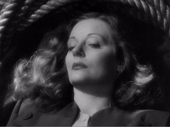 Movie still from “Lifeboat” (1944), directed by Alfred Hitchcock – A black and white photo of a woman in a hat; Close Up shot, High angle