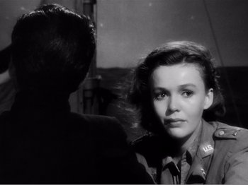 Movie still from “Lifeboat” (1944), directed by Alfred Hitchcock – A young woman in a military uniform looking at a man; Close Up shot, Over the shoulder angle