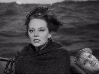Movie still from “Lifeboat” (1944), directed by Alfred Hitchcock – A black - and - white photo of a woman in a shawl; Close Up shot, Over the shoulder angle
