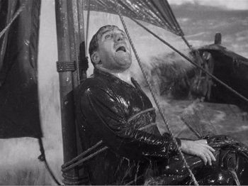 Movie still from “Lifeboat” (1944), directed by Alfred Hitchcock – An old photo of a man in a leather jacket; Wide shot, High angle