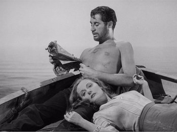 Movie still from “Lifeboat” (1944), directed by Alfred Hitchcock – A black and white photo of a man and a woman on a boat; Medium shot, High angle