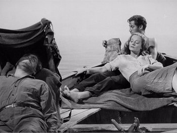 Movie still from “Lifeboat” (1944), directed by Alfred Hitchcock – A black and white photo of a group of people on a boat; Wide shot, High angle