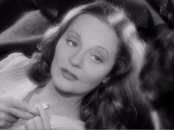 Movie still from “Lifeboat” (1944), directed by Alfred Hitchcock – An old black and white photo of a woman; Close Up shot, High angle