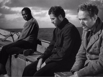 Movie still from “Lifeboat” (1944), directed by Alfred Hitchcock – A group of people sitting on a boat in the ocean; Medium shot, Low angle
