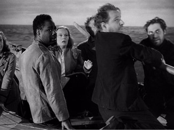 Movie still from “Lifeboat” (1944), directed by Alfred Hitchcock – A black and white photo of a group of people on a boat; Medium shot, High angle