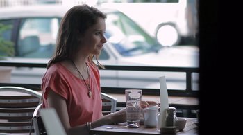 Movie still from “Like Crazy” (2011), directed by Drake Doremus – A woman sitting in front of a laptop computer at a table; Medium shot, Over the shoulder angle