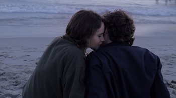 Movie still from “Like Crazy” (2011), directed by Drake Doremus – A man and a woman hugging on the beach; Close Up shot, Over the shoulder angle