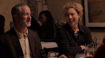 Movie still from “Like Crazy” (2011), directed by Drake Doremus – A man and a woman sitting next to each other at a table; Medium shot, Over the shoulder angle