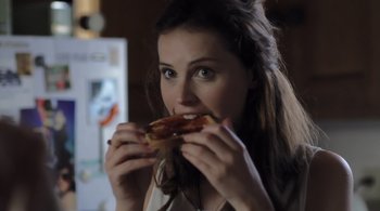 Movie still from “Like Crazy” (2011), directed by Drake Doremus – A woman eating a piece of bacon on a piece of bread; Close Up shot, Over the shoulder angle