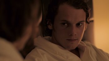 Movie still from “Like Crazy” (2011), directed by Drake Doremus – A young man in a robe looking at the camera; Close Up shot, Over the shoulder angle