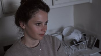 Movie still from “Like Crazy” (2011), directed by Drake Doremus – A person sitting in front of a dish washer; Close Up shot, High angle