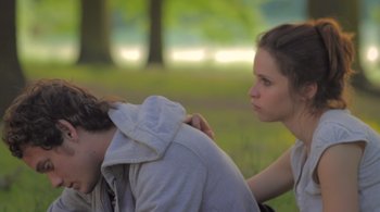 Movie still from “Like Crazy” (2011), directed by Drake Doremus – A man and a woman sitting in the grass; Medium shot, Over the shoulder angle