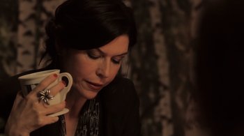 Movie still from “Like Crazy” (2011), directed by Drake Doremus – A woman is holding a cup of coffee and looking at her cell phone; Close Up shot, High angle