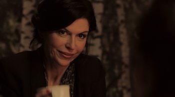Movie still from “Like Crazy” (2011), directed by Drake Doremus – A woman is holding a coffee cup and smiling; Close Up shot, Over the shoulder angle