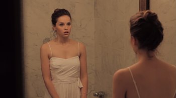 Movie still from “Like Crazy” (2011), directed by Drake Doremus – A woman in a white dress looking in the mirror; Medium shot, Over the shoulder angle