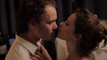 Movie still from “Like Crazy” (2011), directed by Drake Doremus – A man and a woman kissing each other in front of a curtain; Close Up shot, Low angle