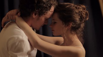 Movie still from “Like Crazy” (2011), directed by Drake Doremus – A man and a woman embracing each other in front of a curtain; Close Up shot, Low angle