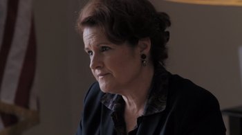 Movie still from “Like Crazy” (2011), directed by Drake Doremus – An older woman looking at the camera while wearing a black shirt; Close Up shot, Over the shoulder angle
