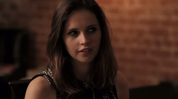 Movie still from “Like Crazy” (2011), directed by Drake Doremus – A beautiful young woman with long brown hair; Close Up shot, Over the shoulder angle