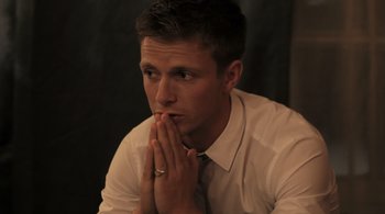 Movie still from “Like Crazy” (2011), directed by Drake Doremus – A man in a white shirt and a tie is holding his hands together; Close Up shot, High angle