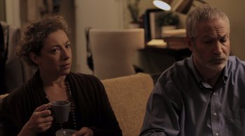 Movie still from “Like Crazy” (2011), directed by Drake Doremus – A woman and a man sitting on a couch talking to each other; Medium shot, Over the shoulder angle