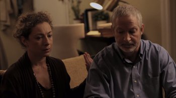 Movie still from “Like Crazy” (2011), directed by Drake Doremus – An older man and a younger woman sitting in a living room; Medium shot, Over the shoulder angle